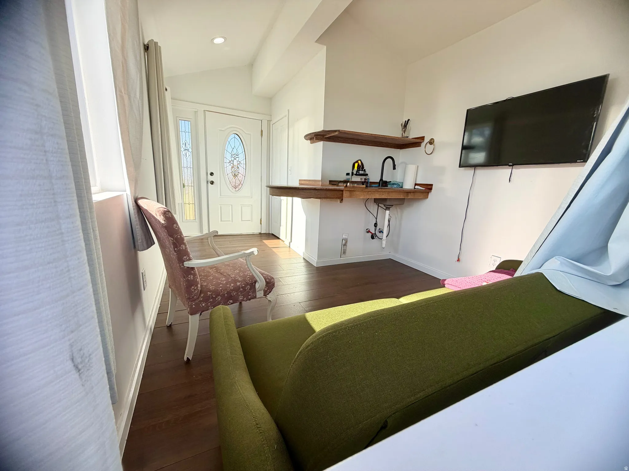 Bright interior space featuring wood-finish flooring and white walls