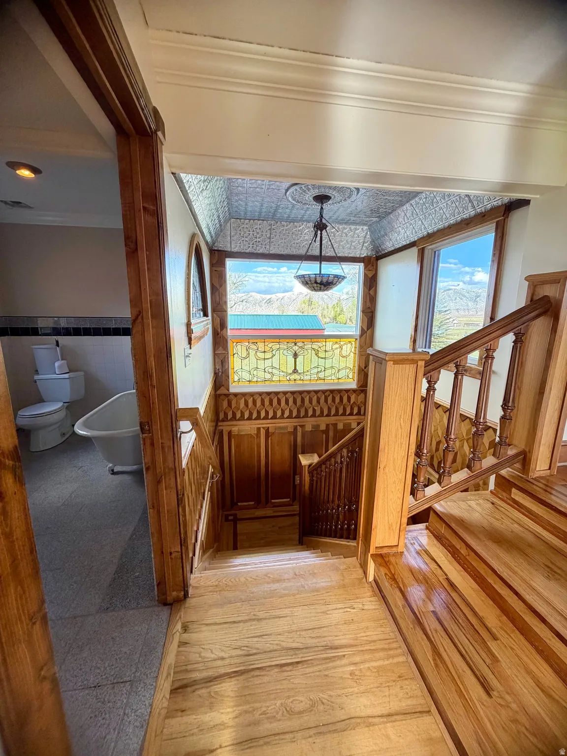 Hardwood staircase with ornate wood newel posts and railings