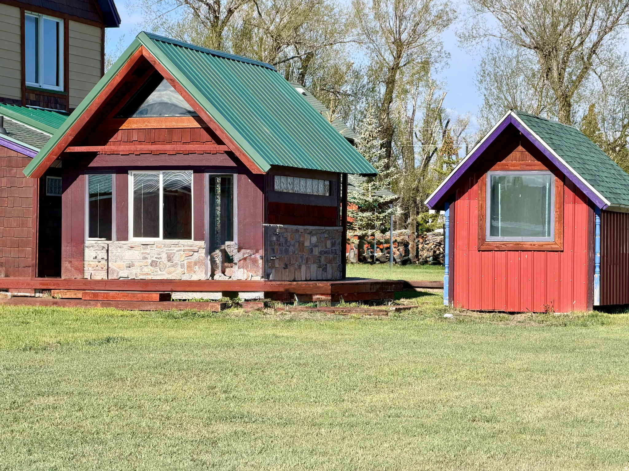 Two detached structures with brightly colored siding