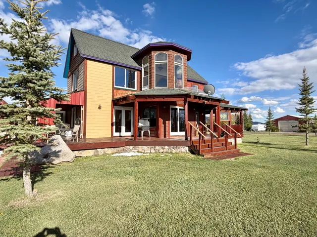 Multi-level residence featuring a prominent polygonal bay window and varied exterior siding