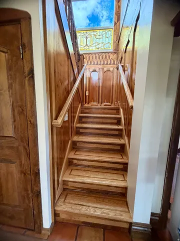 Solid wood staircase featuring dual-tone treads and risers