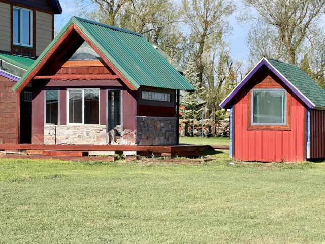 Two detached structures with brightly colored siding
