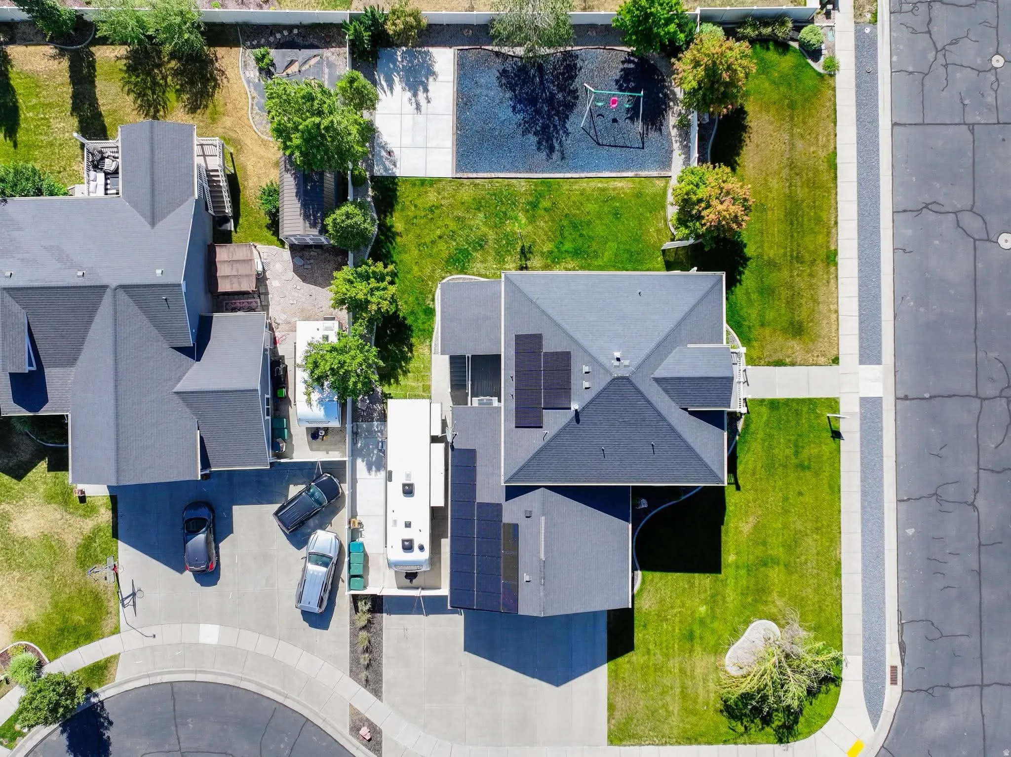 Contemporary residential property featuring a gray shingle roof and solar panel array