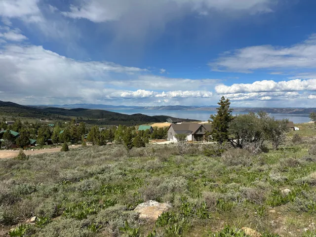 Expansive natural landscape with distant water and mountain scenery