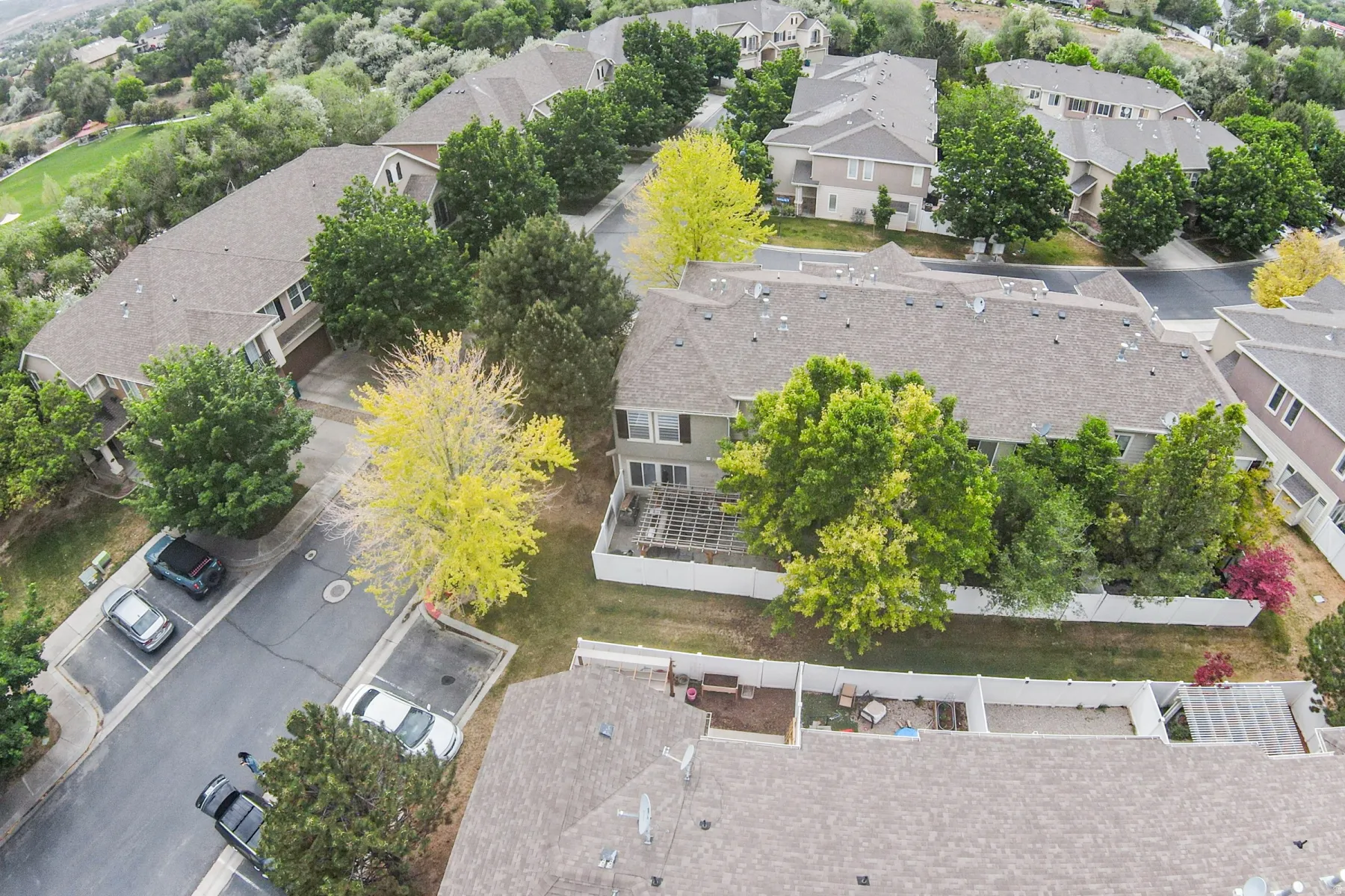 Aerial perspective showcasing a residential community with varied rooflines and mature trees