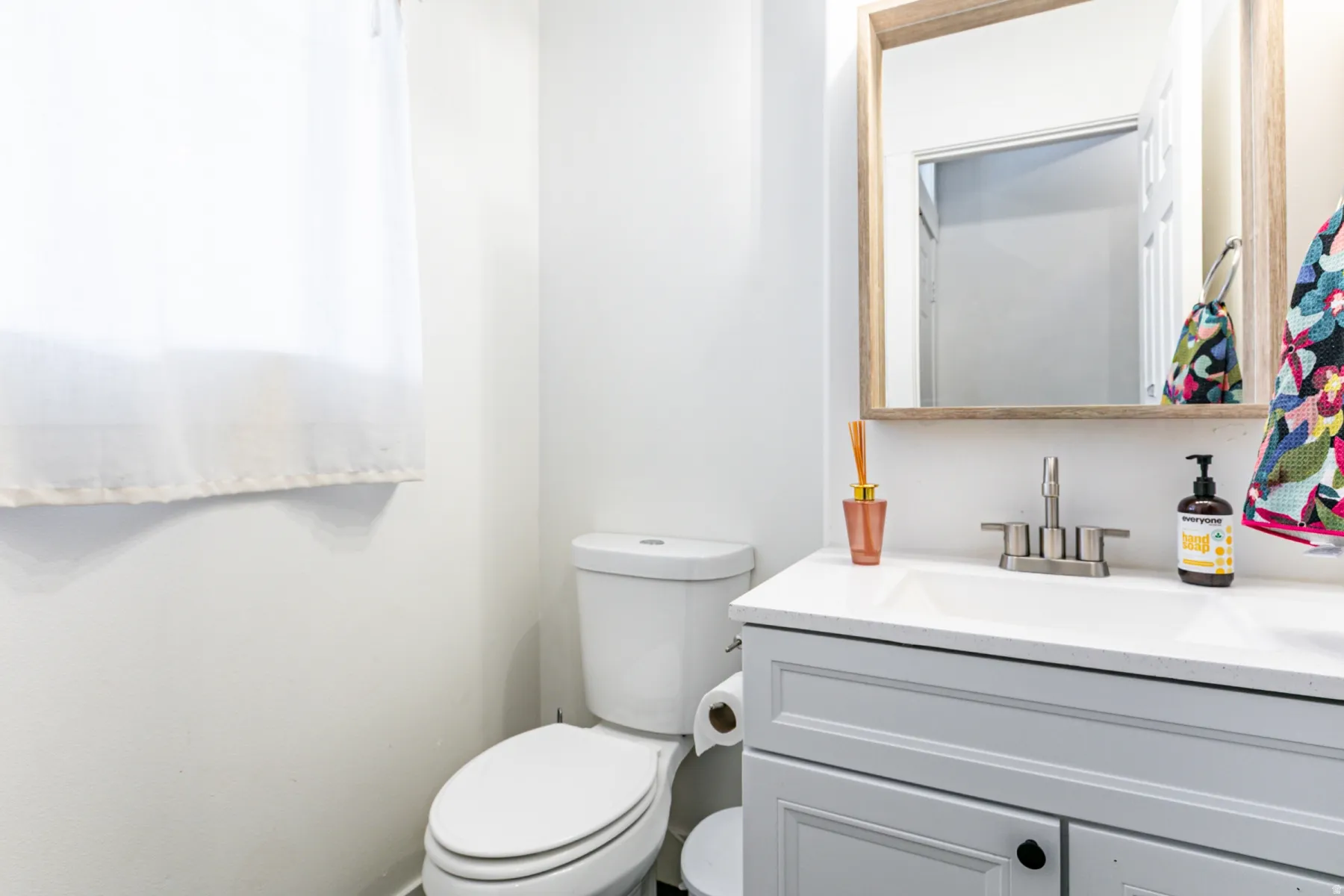 Bathroom featuring a vanity with a white countertop, undermount sink, and brushed nickel faucet