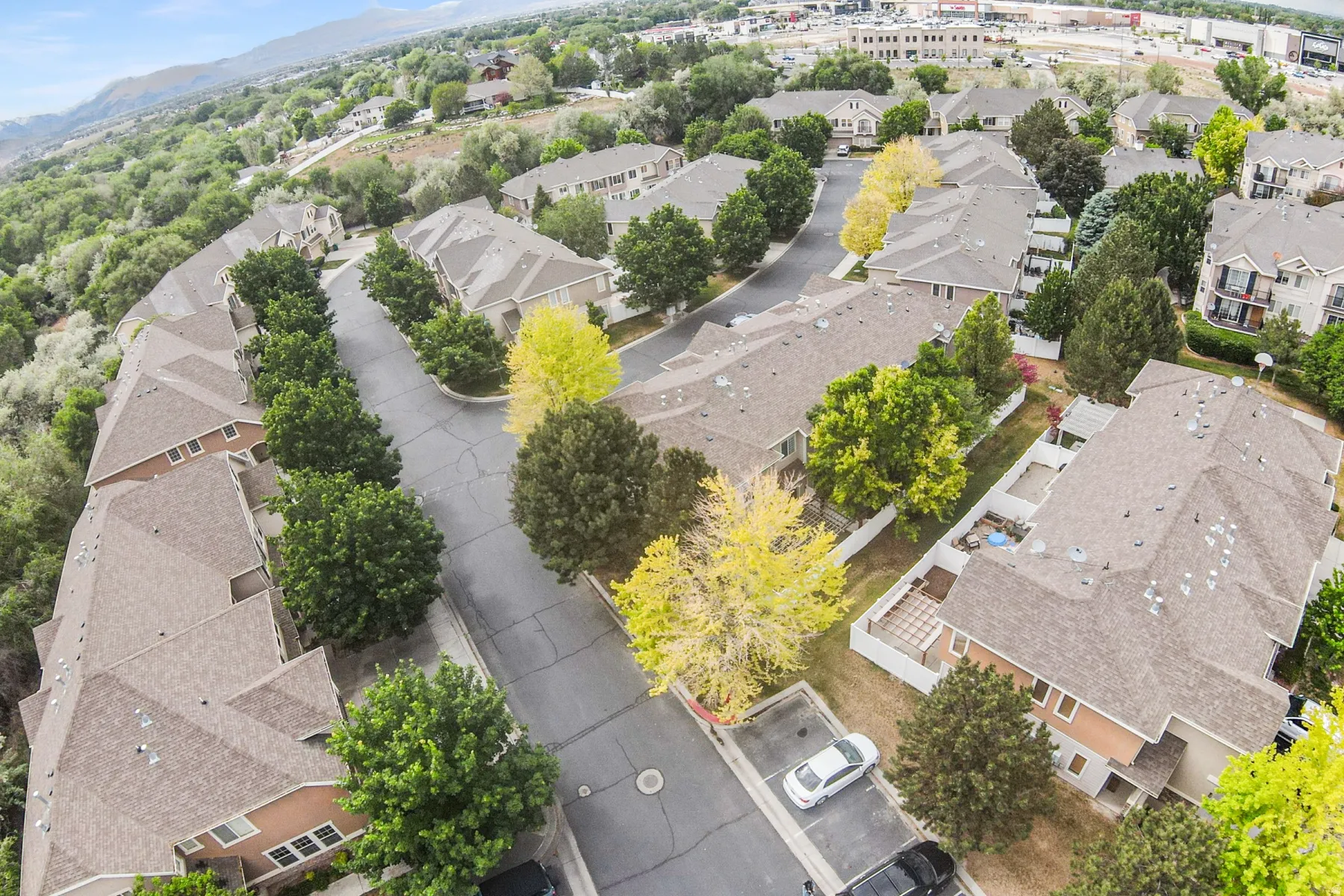 Aerial perspective showcasing a residential community with numerous townhome-style residences