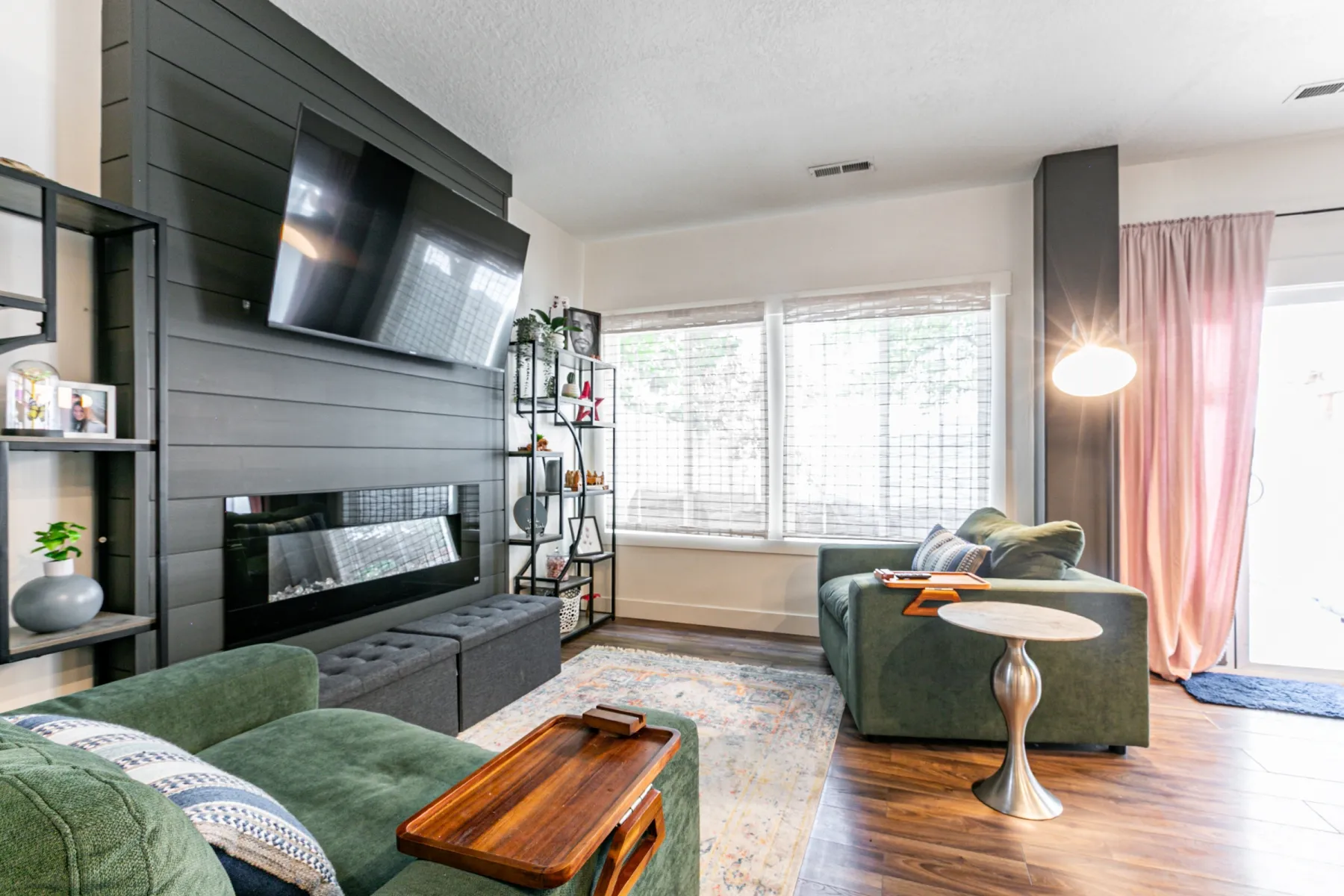 Living area featuring a floor-to-ceiling shiplap accent wall with a built-in linear fireplace