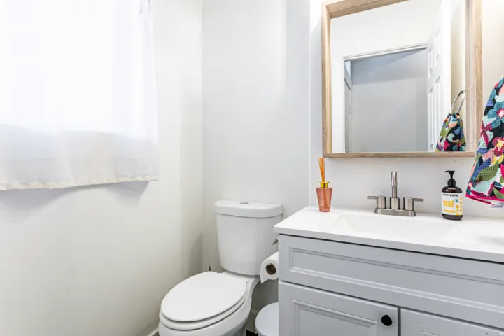 Bathroom featuring a vanity with a white countertop, undermount sink, and brushed nickel faucet