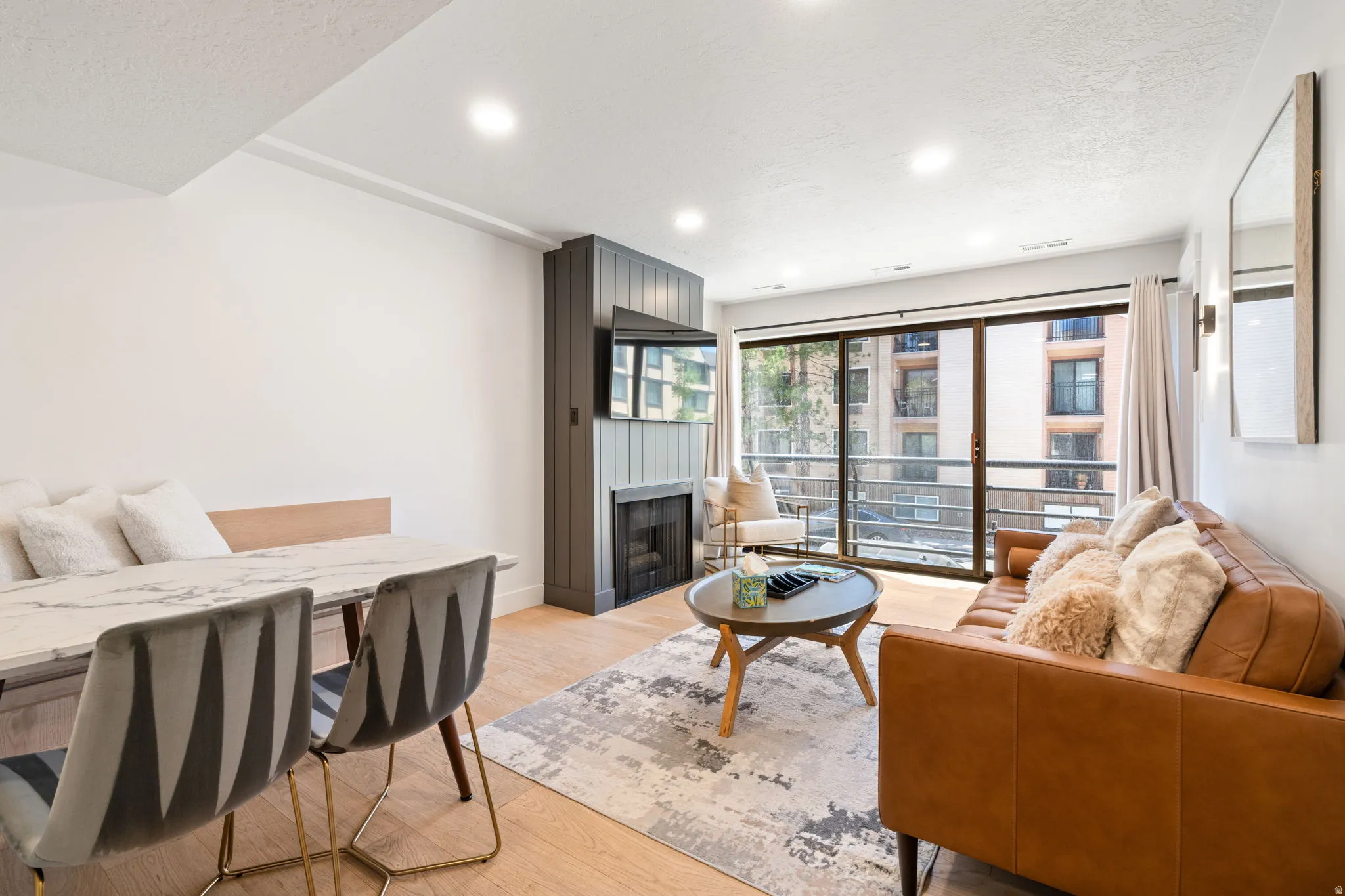 Open-concept living area featuring light wood-finish flooring and recessed lighting