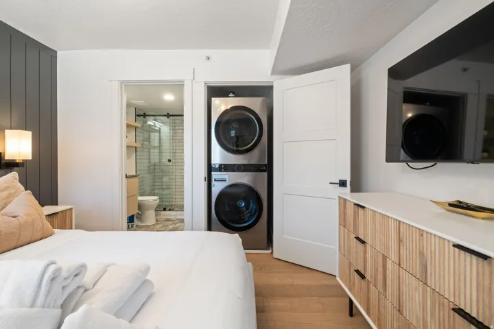 Integrated laundry closet featuring stacked appliances