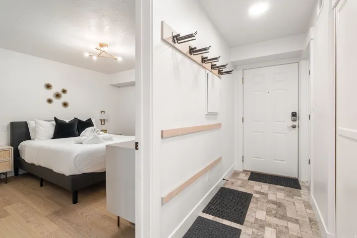 Entryway featuring patterned floor tiles and a white paneled door with smart lock hardware