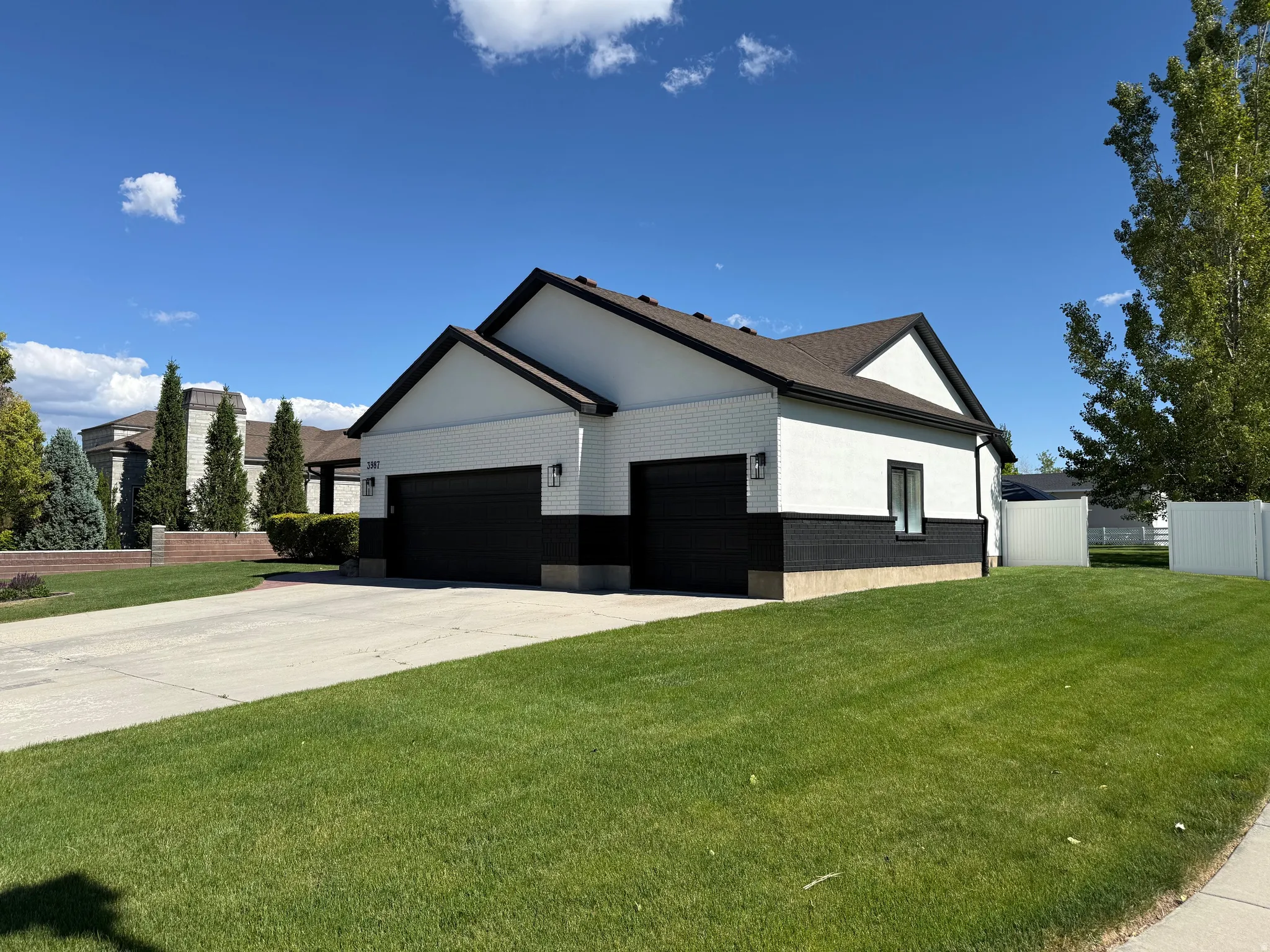Modern exterior featuring white brick and dark trim accents