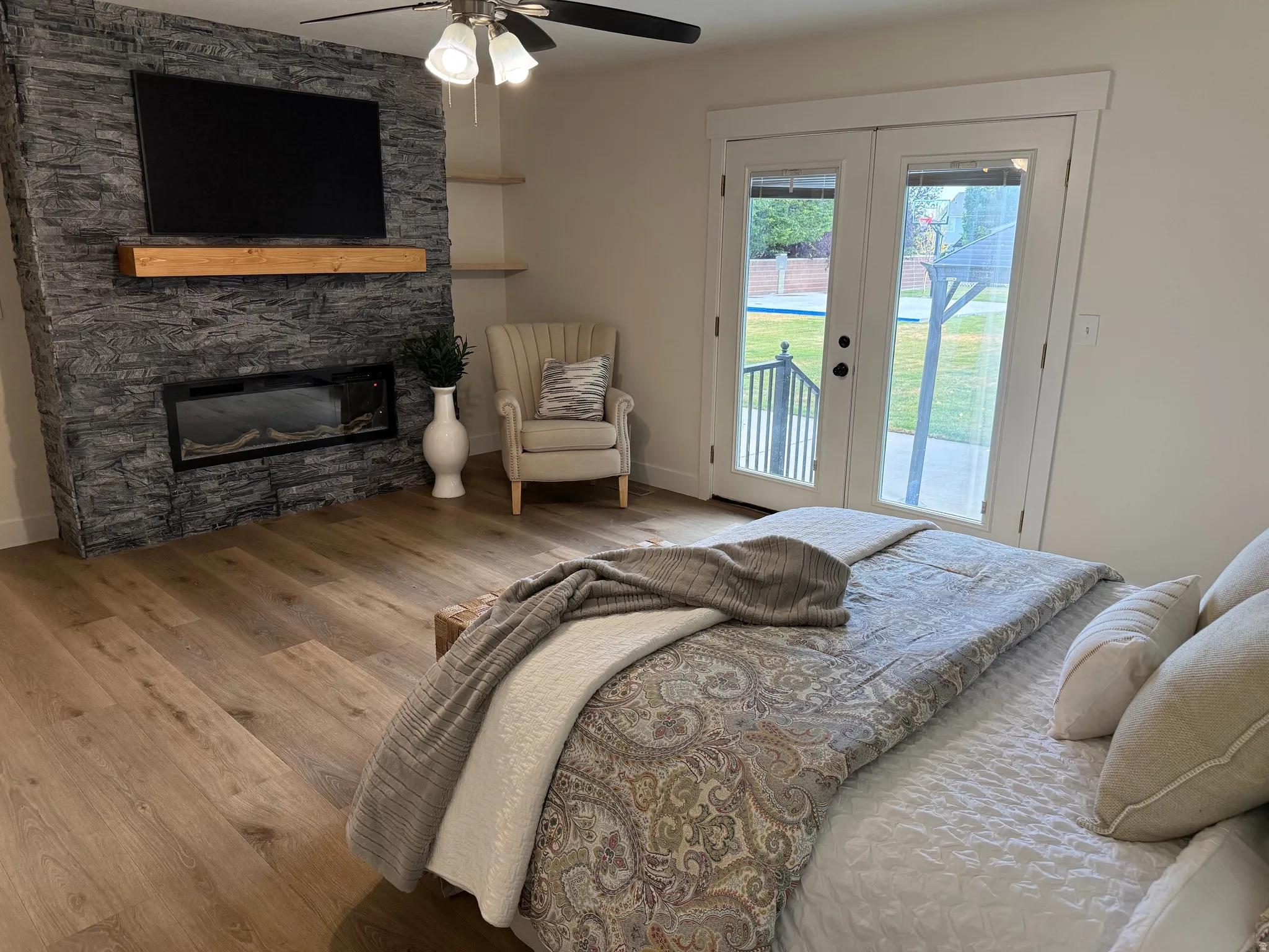 Accent wall featuring stacked stone and a linear electric fireplace