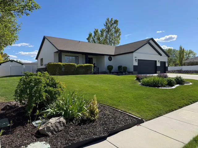 Contemporary ranch exterior featuring white siding with dark trim accents and a dark shingle roof