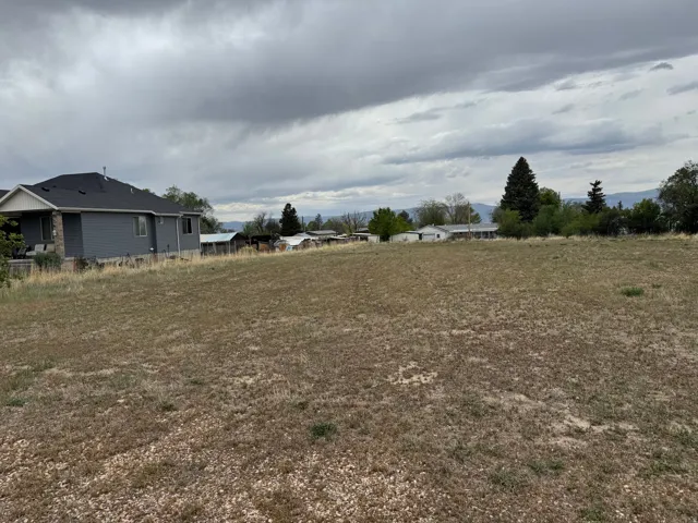 Expansive undeveloped lot featuring a gentle slope and distant mountain views