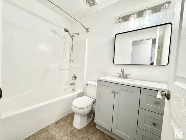 White integrated tub and shower unit with chrome fixtures