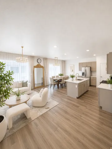 Open-concept living space featuring wood-finish flooring, recessed lighting, a crystal chandelier, and large windows with sheer white drapery