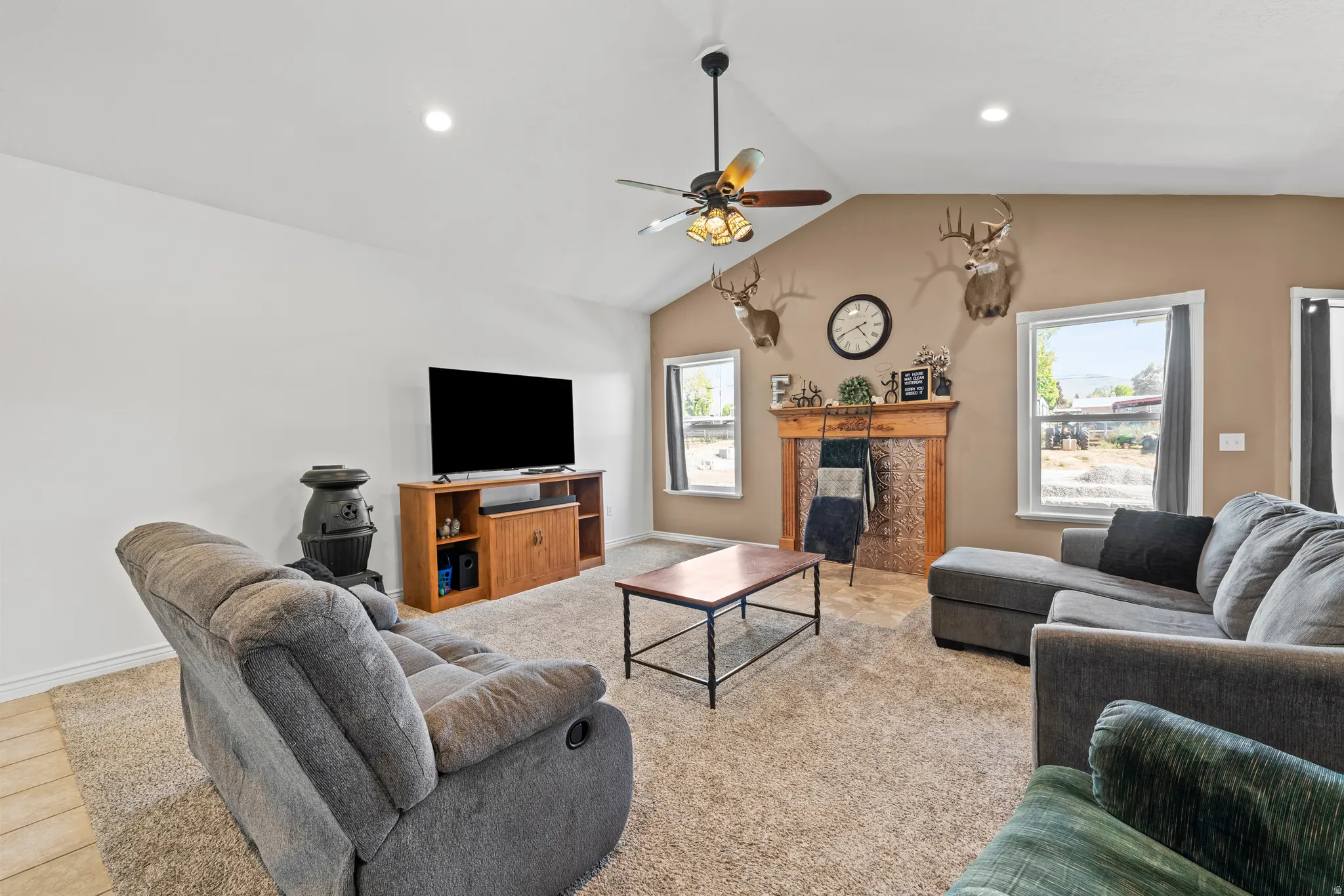 Vaulted ceiling featuring a ceiling fan with integrated lighting