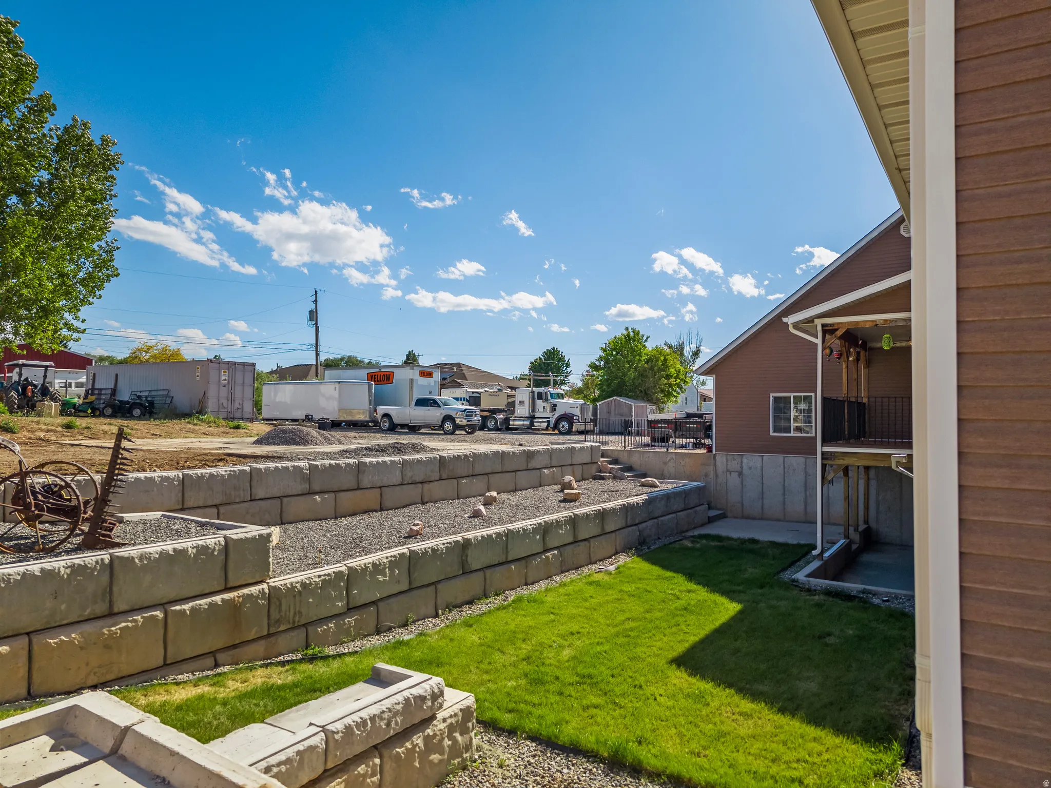 Terraced yard featuring concrete block retaining walls and gravel beds