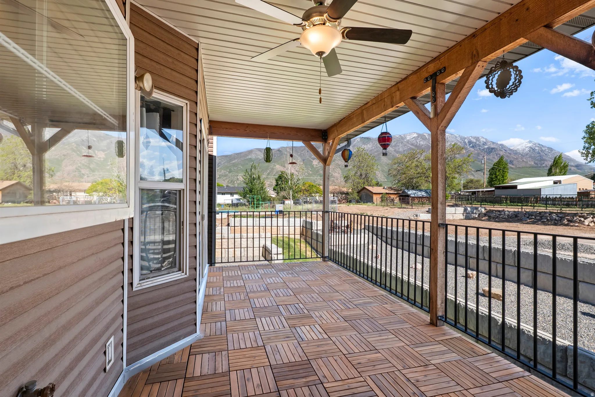 Covered patio featuring wood-finish flooring and a ceiling fan