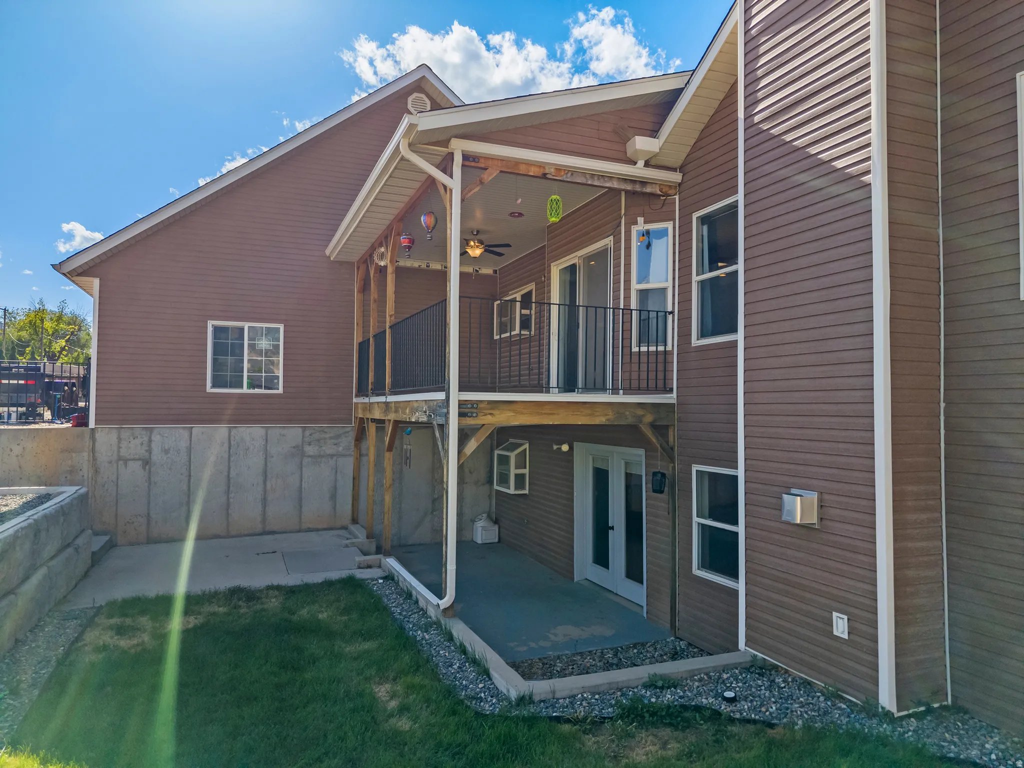 Exterior featuring brown siding, white trim, and a concrete foundation