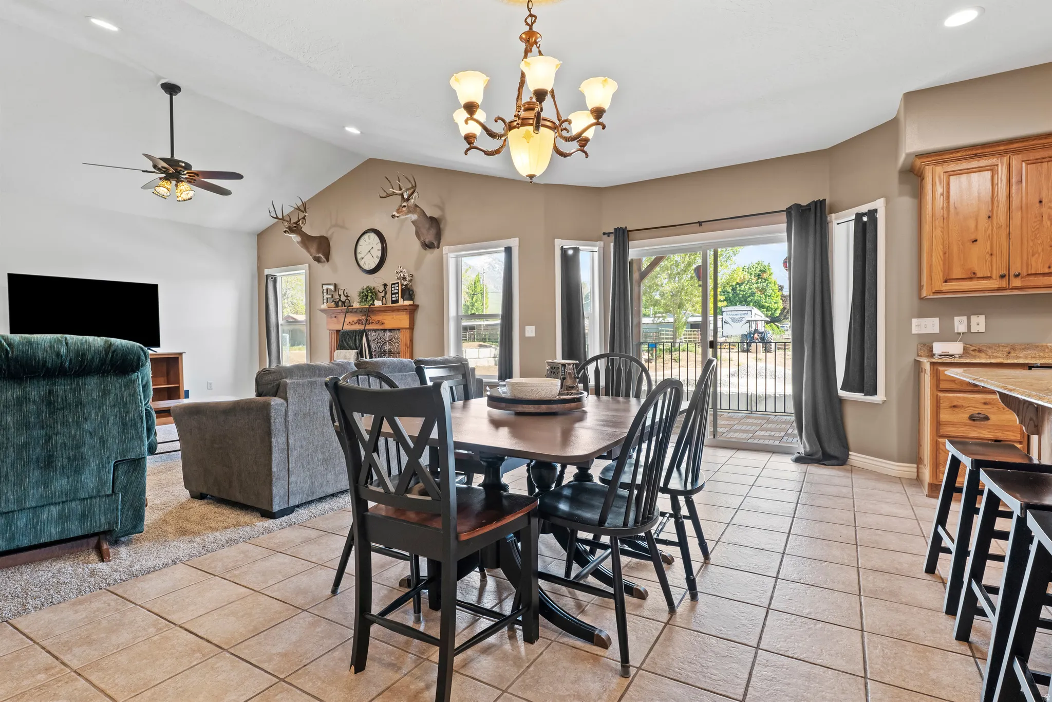 Open-concept dining area featuring a wood-finish table and tile flooring