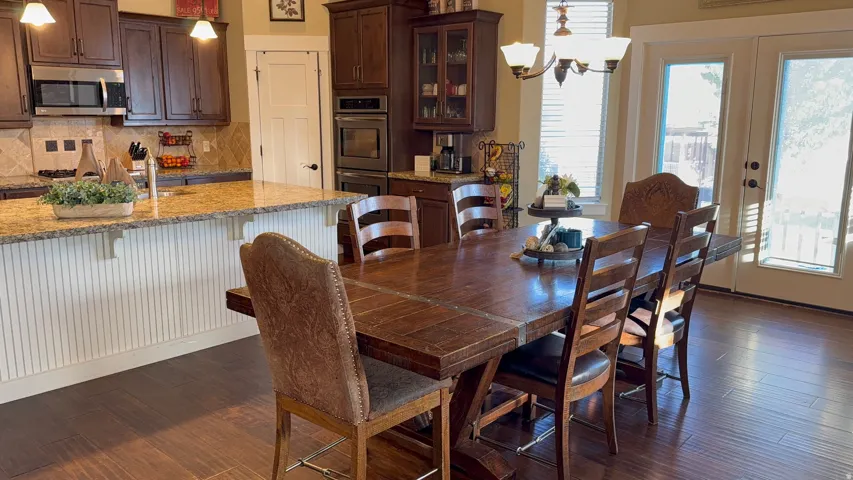 Large Open-concept dining area featuring wood-finish flooring and a multi-light chandelier