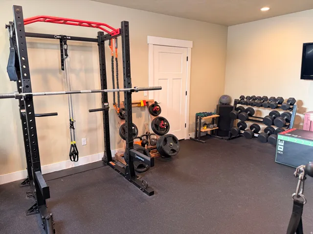Dedicated exercise room featuring a rubberized floor and recessed lighting