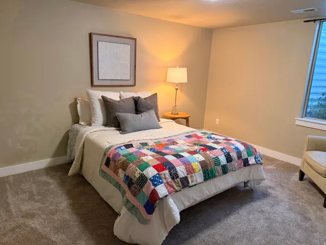Carpeted room featuring a single window, baseboard trim, and neutral wall tones