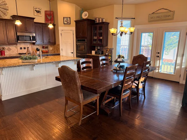 Kitchen with dark wood-finish cabinetry and stainless steel appliances