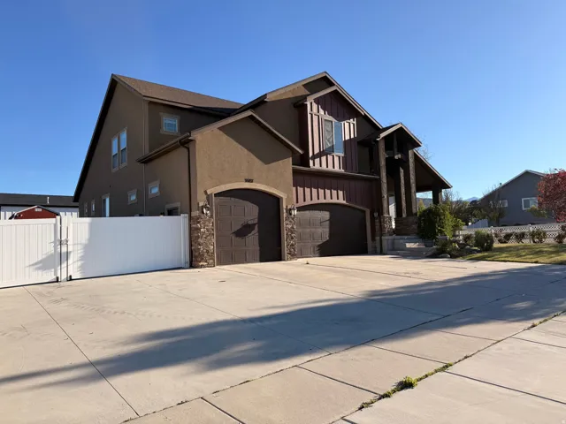 Huge RV parking. Contemporary residence featuring a stucco and siding facade with stone accents
