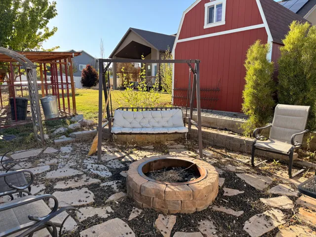 Stone paver patio featuring a built-in block fire pit