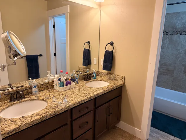 Double vanity featuring granite countertops and undermount sinks