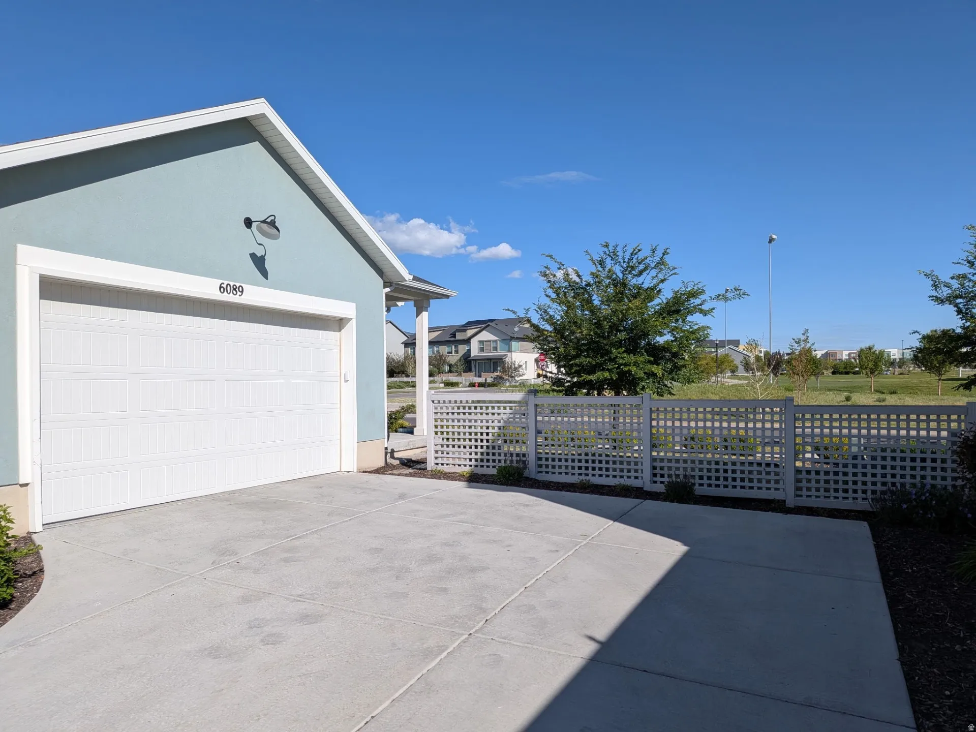 Attached two-car garage with a white paneled door