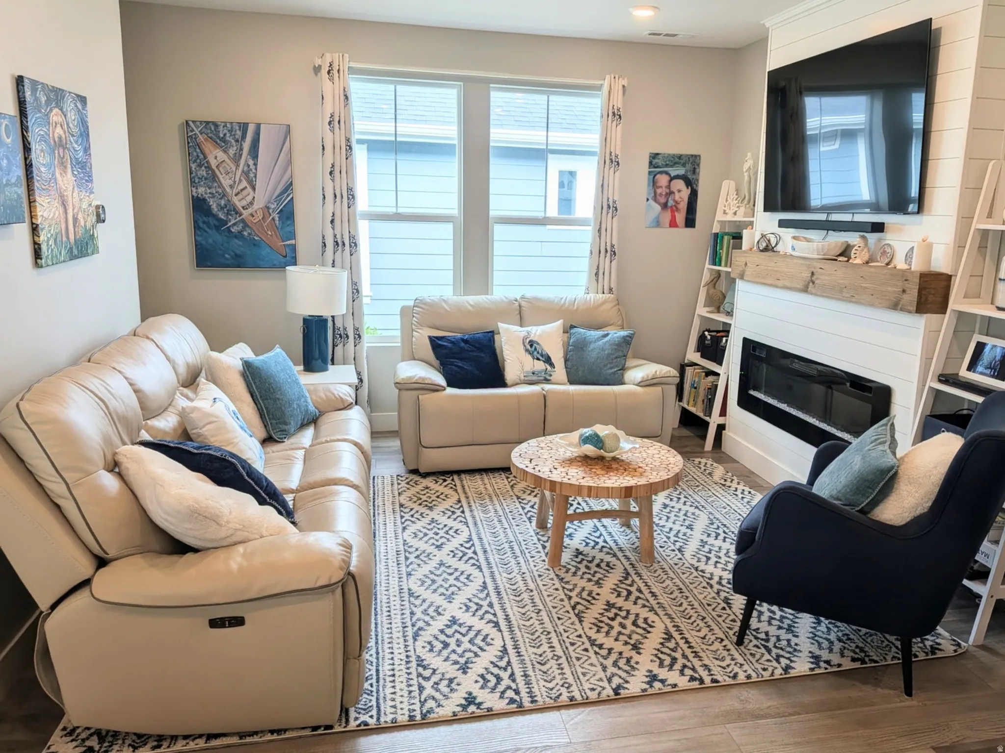 Living area featuring recessed lighting, multi-pane windows, wood-finish flooring, and a white shiplap fireplace with a rustic wood mantel