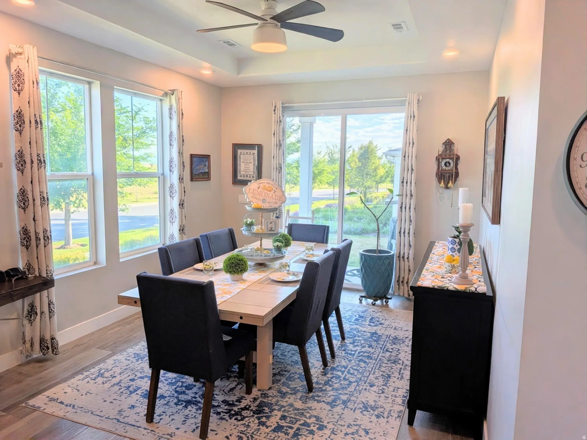 Dining space featuring wood-finish flooring, a tray ceiling, and recessed lighting