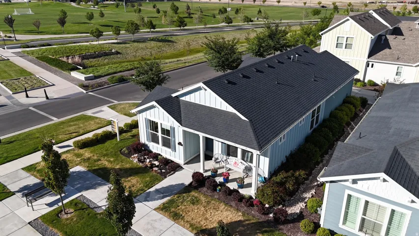 Light blue siding home featuring a dark shingle roof and white trim