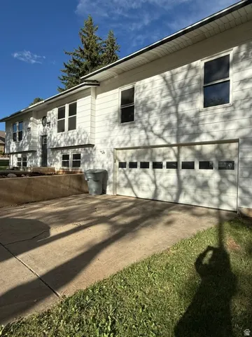 Split-level exterior with horizontal siding and multiple windows