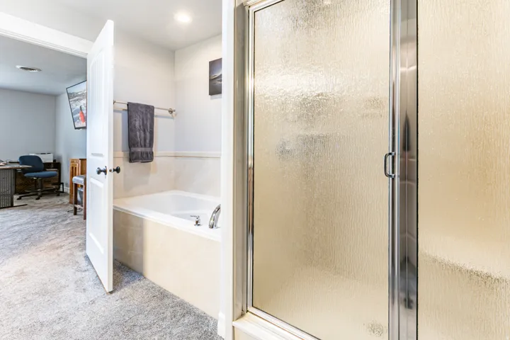 Frosted glass shower enclosure with chrome hardware