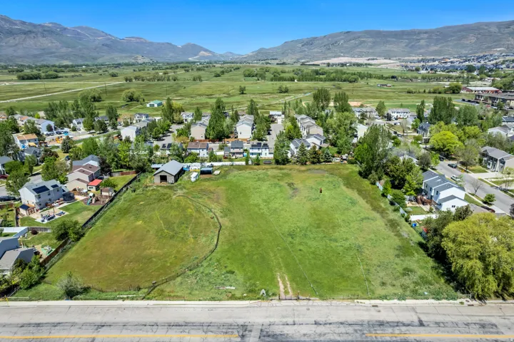 Expansive green lot bordered by residential properties