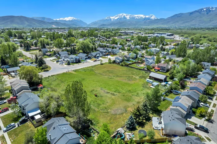 Expansive green lot surrounded by residential development