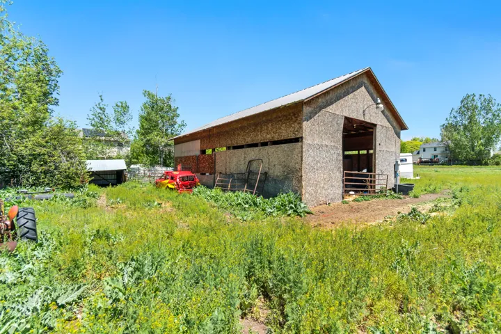 Large barn structure with a metal roof and open bay