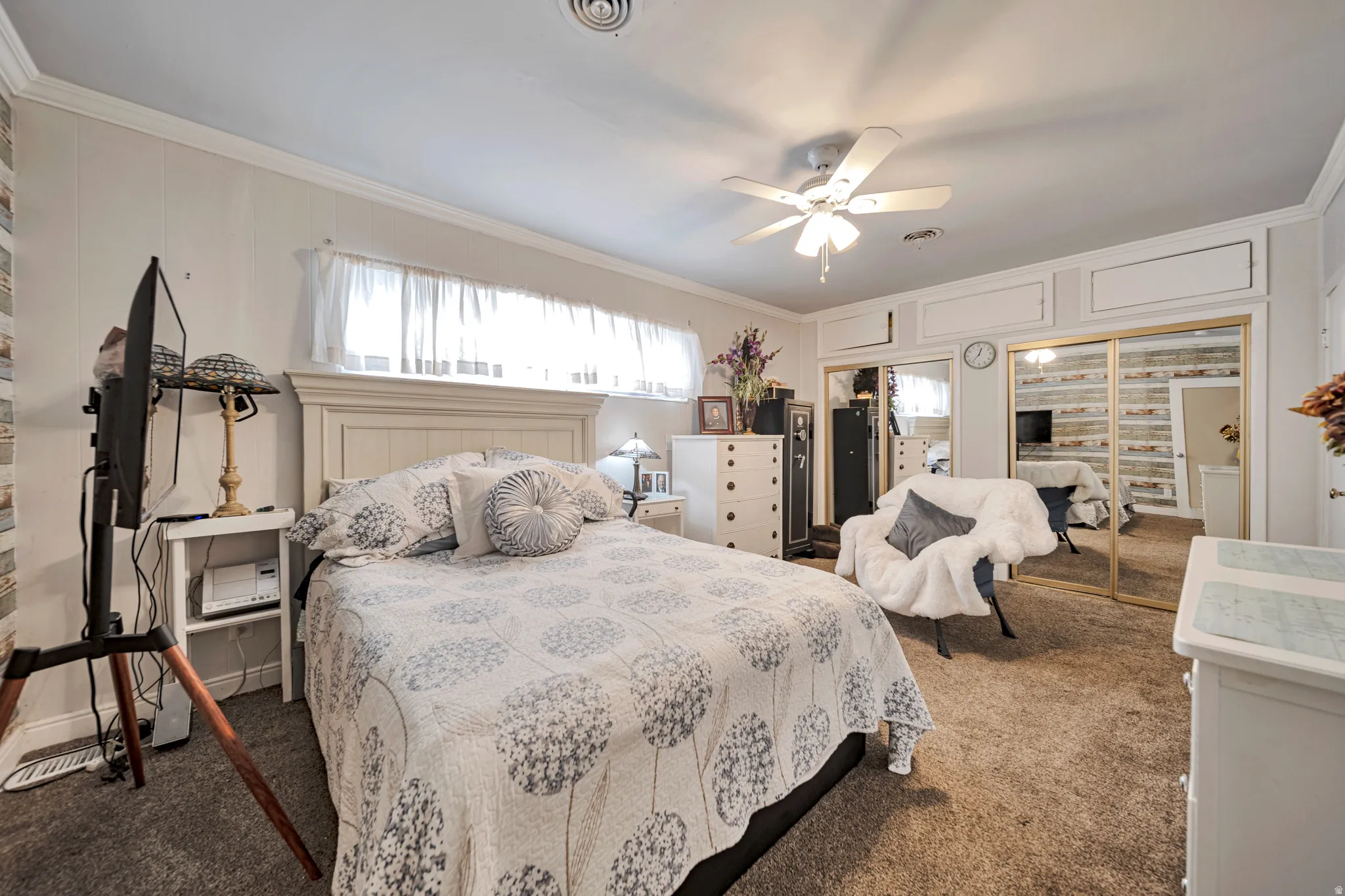 Bedroom featuring carpeted flooring and a built-in closet with mirrored sliding doors