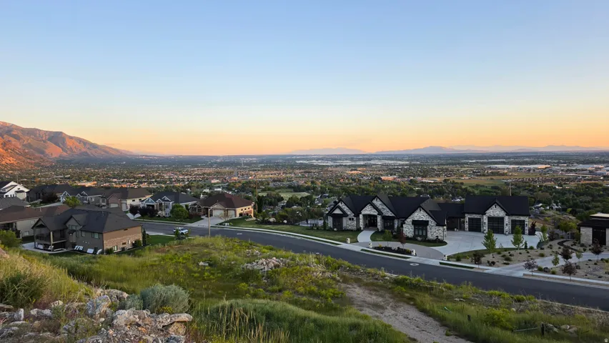 Modern residences featuring stone and dark siding exteriors, prominent black roofing, and multi-car garages