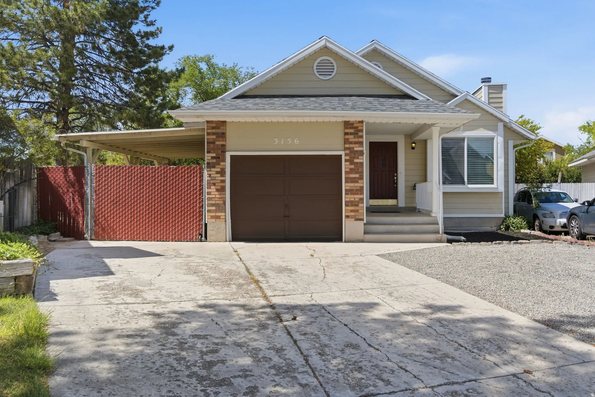 Light-toned siding exterior with brick accents and a dark brown garage door