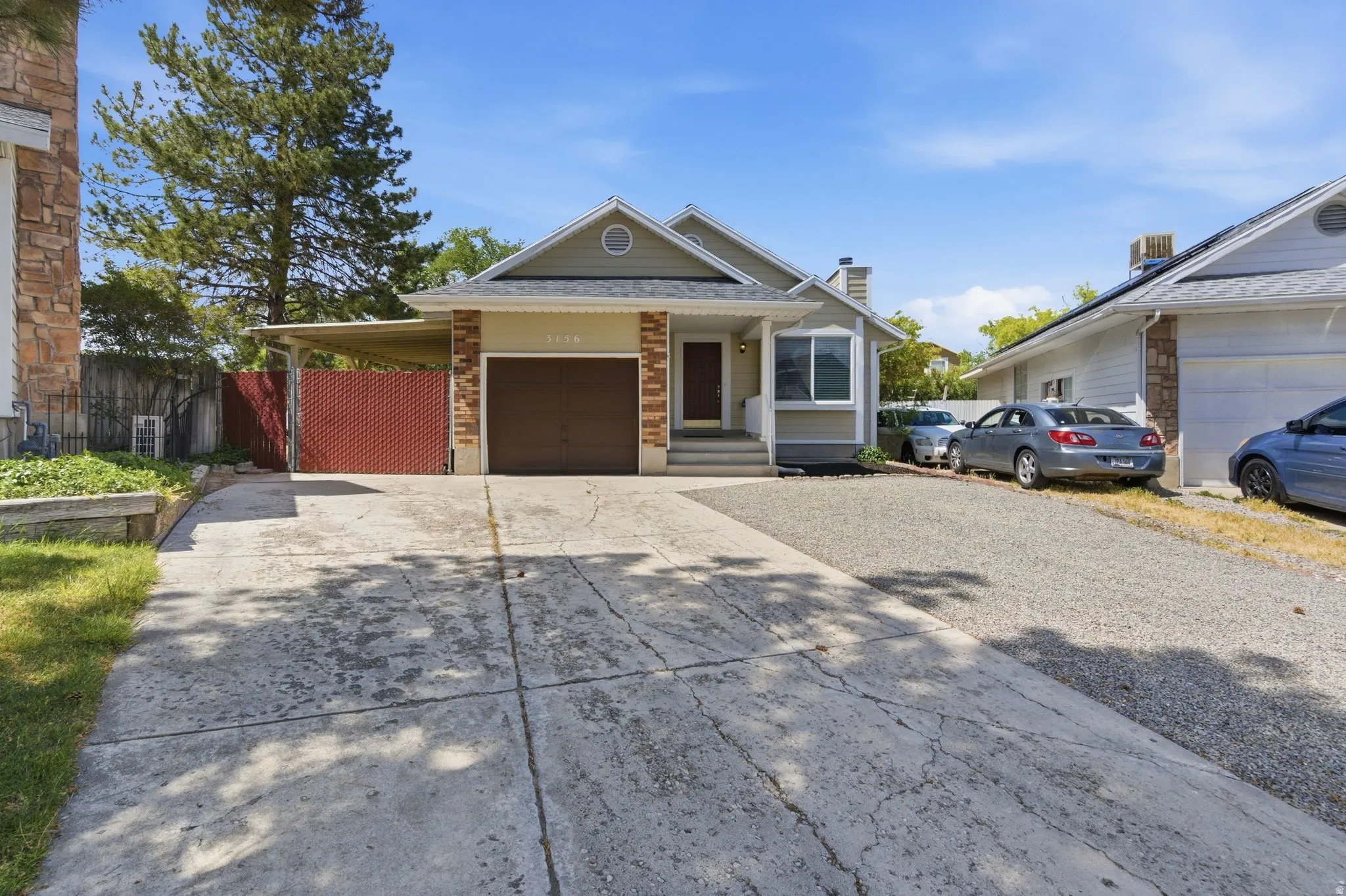 Single-story residence featuring a front entry, attached garage with a brown door, and stone facade accents