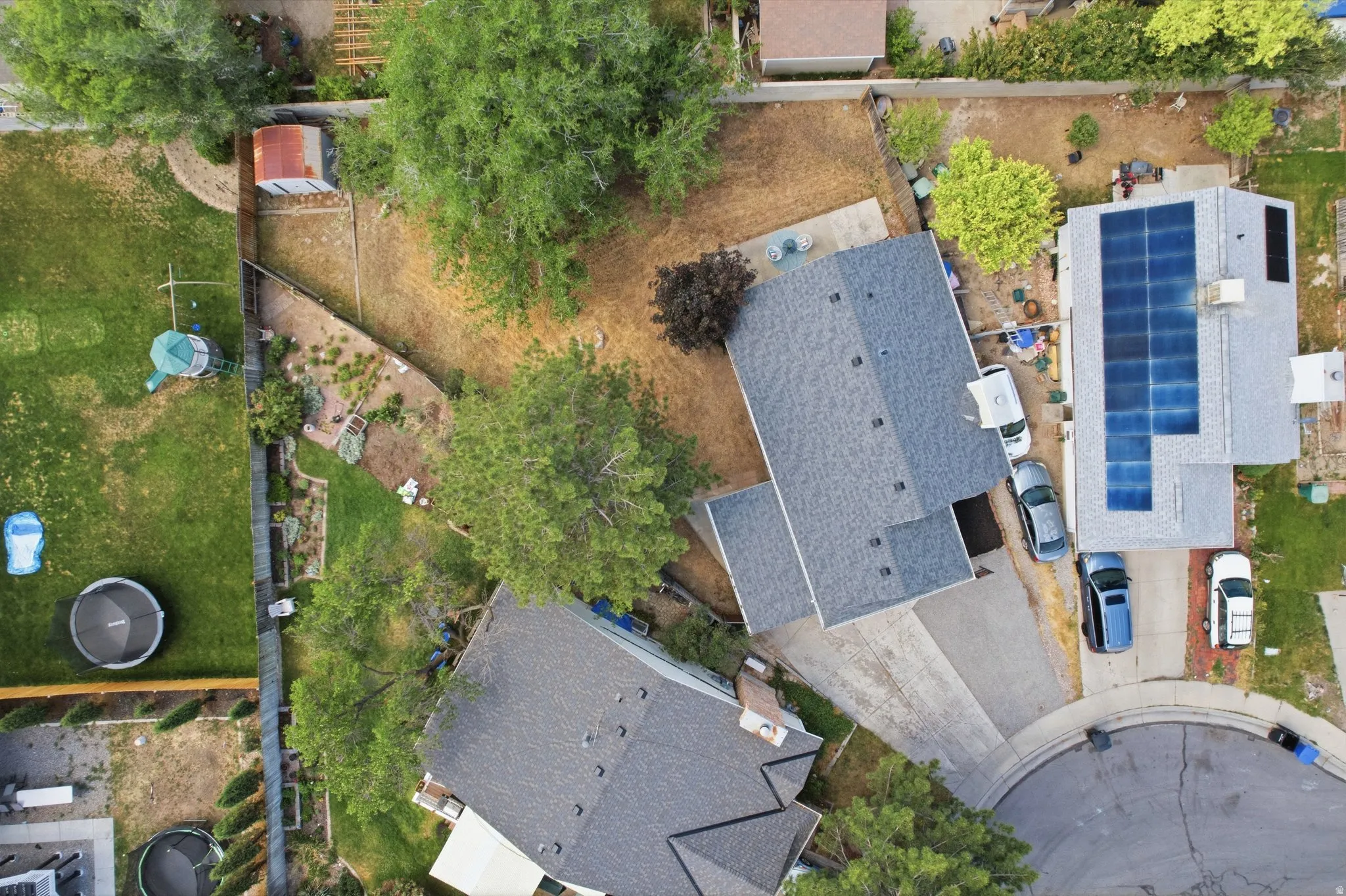 Aerial view showcasing a residential property with a shingle roof