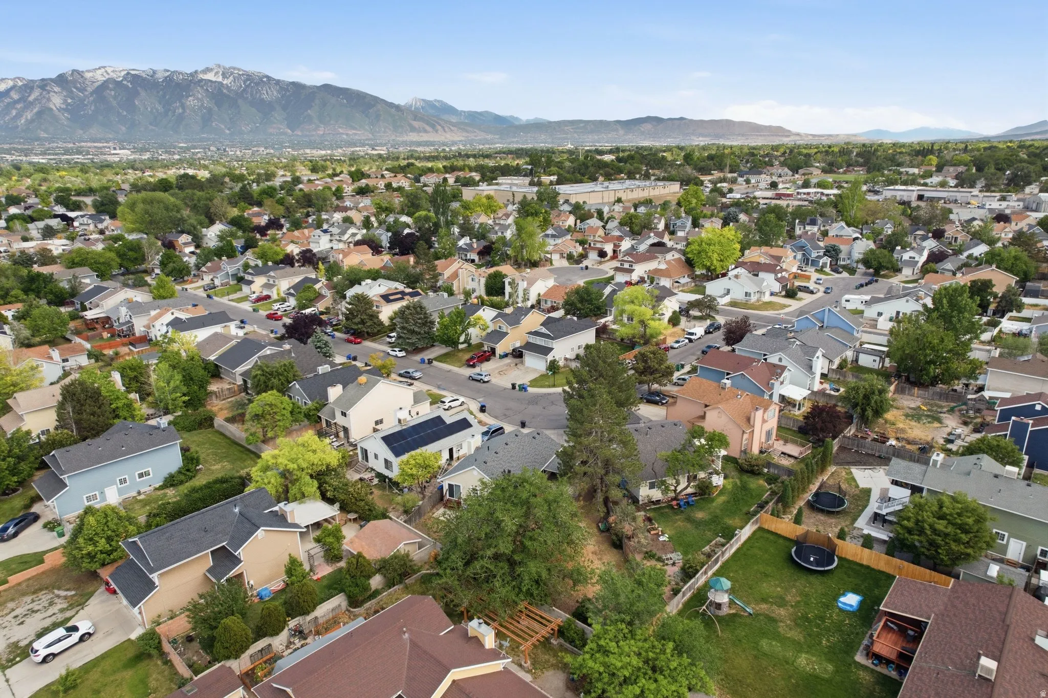 Expansive neighborhood panorama framed by distant mountains