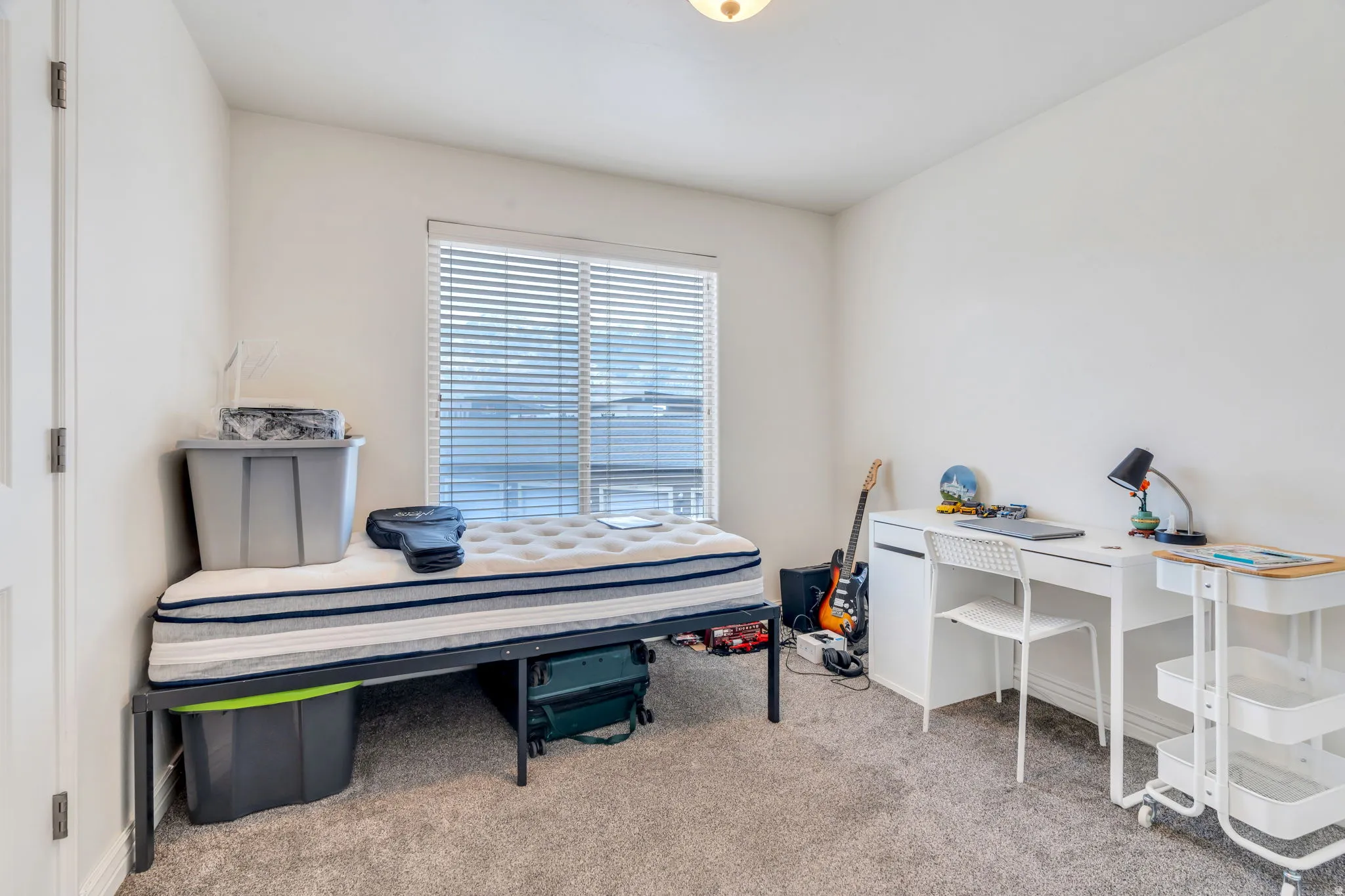 Neutral wall tones with a window featuring horizontal blinds